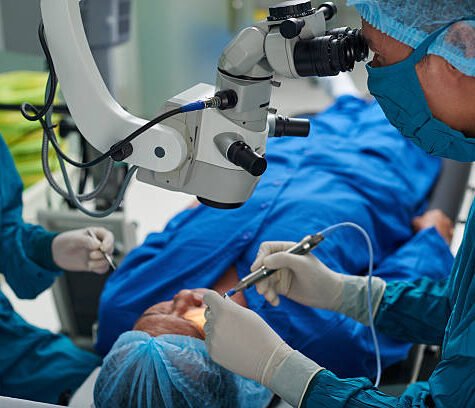 Doctor performing eye surgery in modern clinic